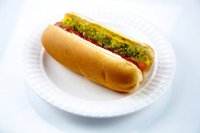 hot dog with relish ketchup mustard on plate